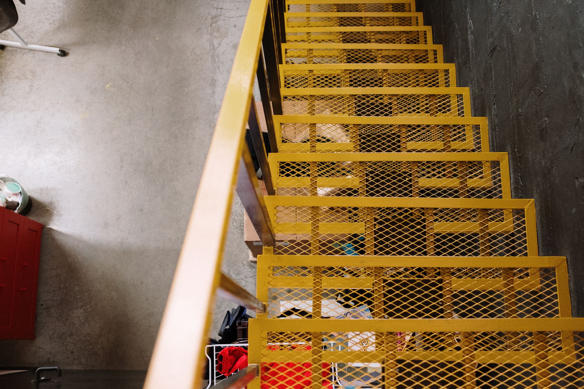 Bright yellow metal staircase adds a bold touch to this industrial loft space.