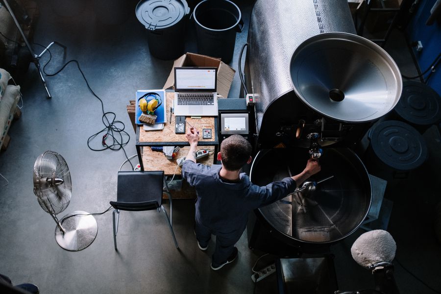 Kaffeerösterei von oben, der Inhaber arbeitet am Laptop