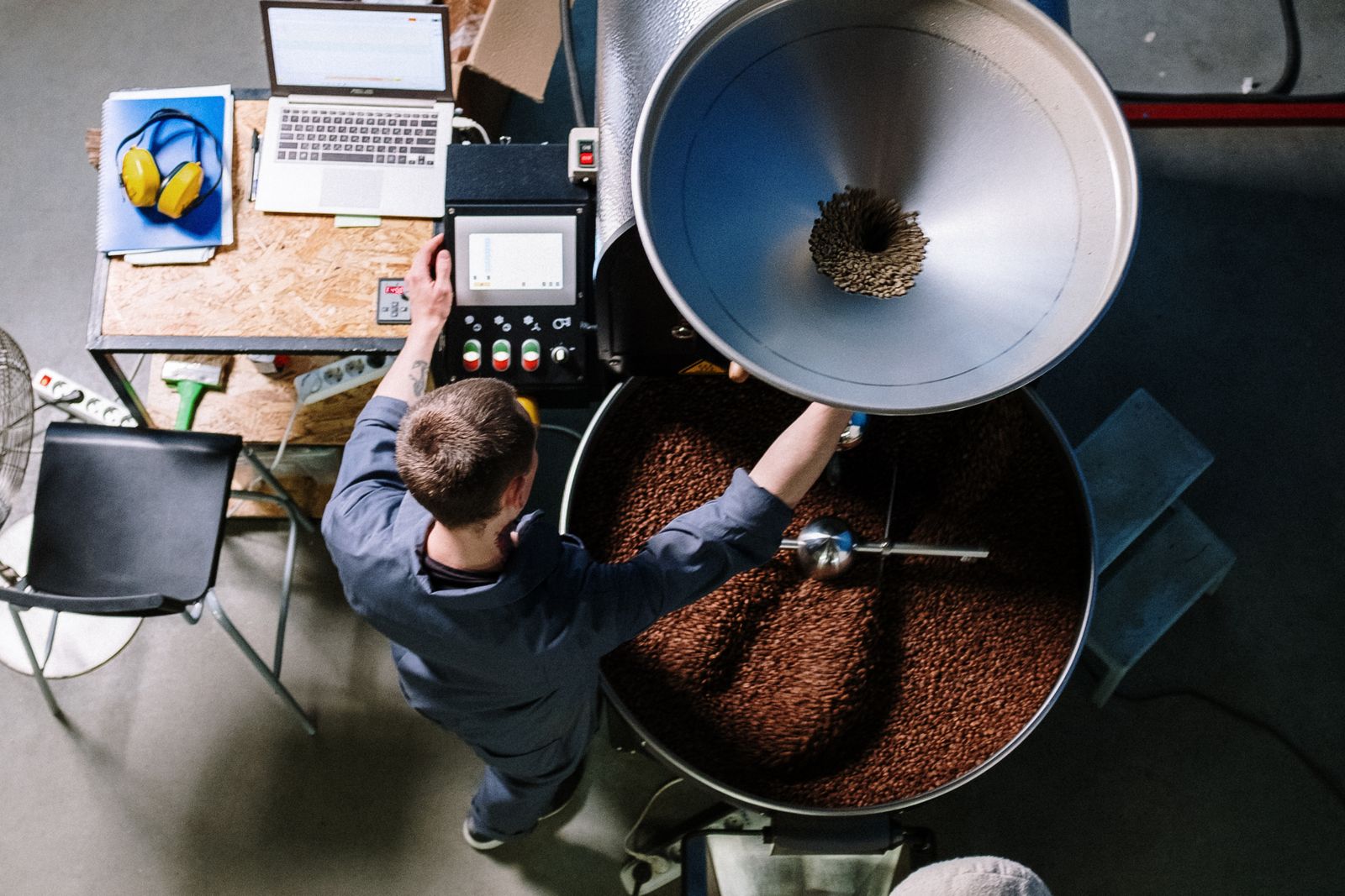 Roaster tending a drum roaster in the Tin Whistle roastery, photo by cottonbro studio on Pexels