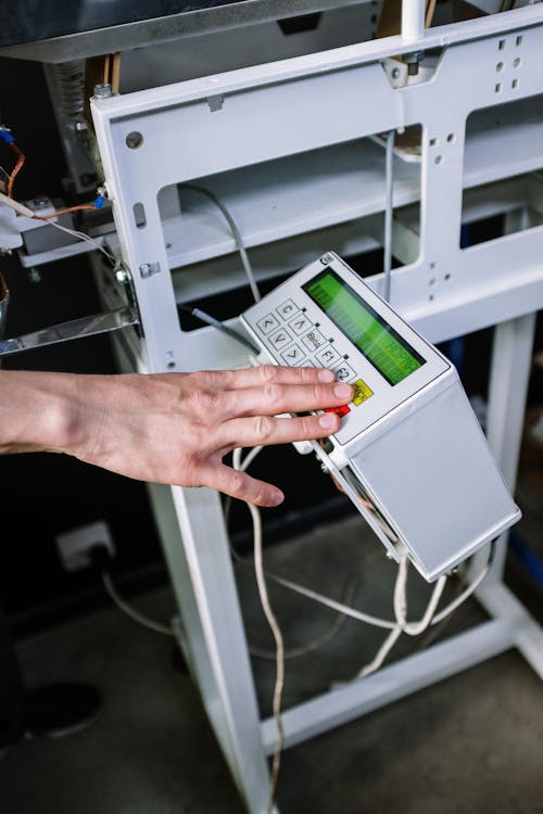 Person Holding White and Green Digital Device