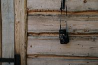 Black and Silver Steel Padlock on Brown Wooden Wall