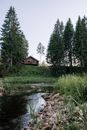 Brown Wooden House Near Green Trees and River