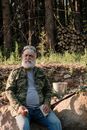 Man in Green Jacket Sitting on Ground
