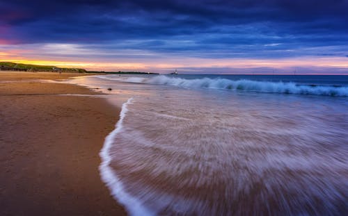 Long Exposure of Waves on a Beach at Sunset 