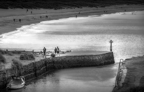 Black and White Photo of People on Beach