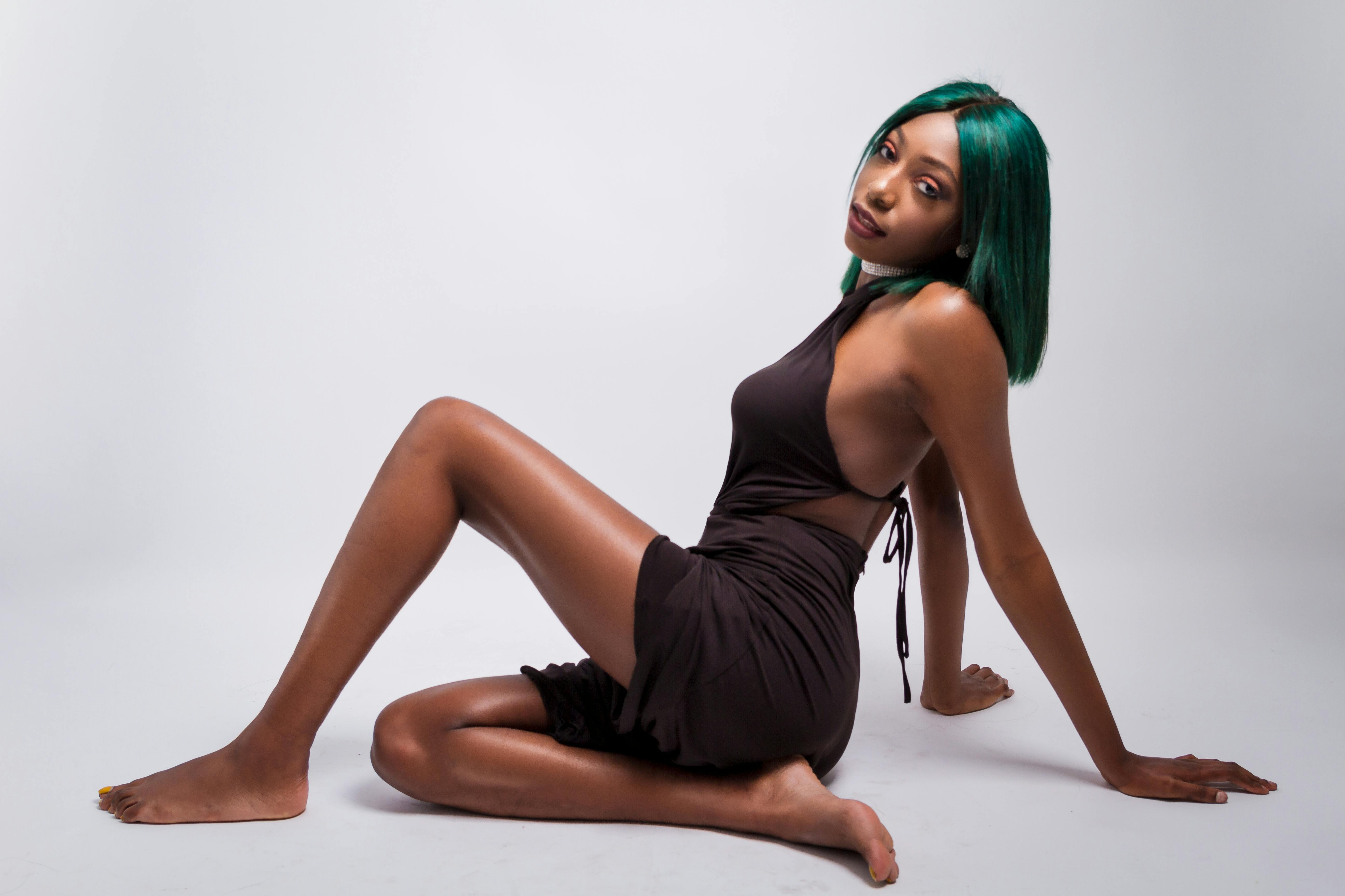 photograph of a woman with green hair posing