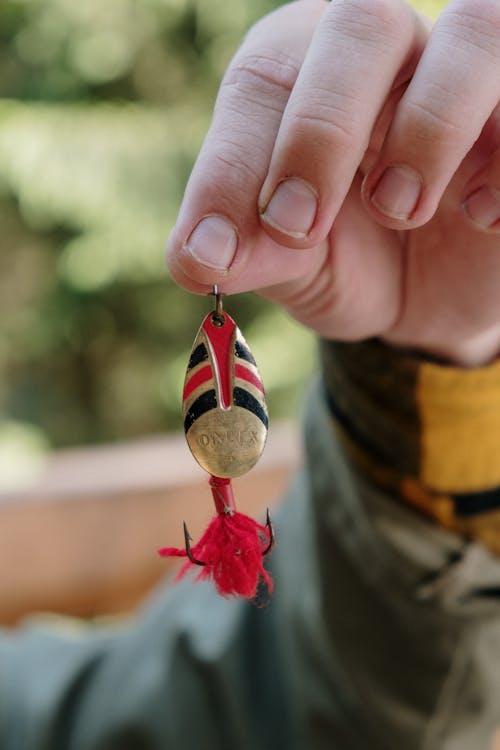 Person Holding Red and White Heart Ornament