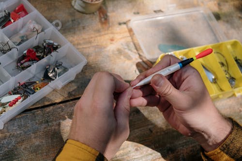 Person Holding White and Brown Cigarette Stick