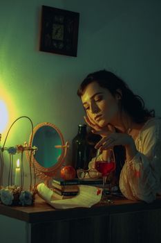 一个女人喝着酒，点着蜡烛，看着书，享受一个安静的夜晚
