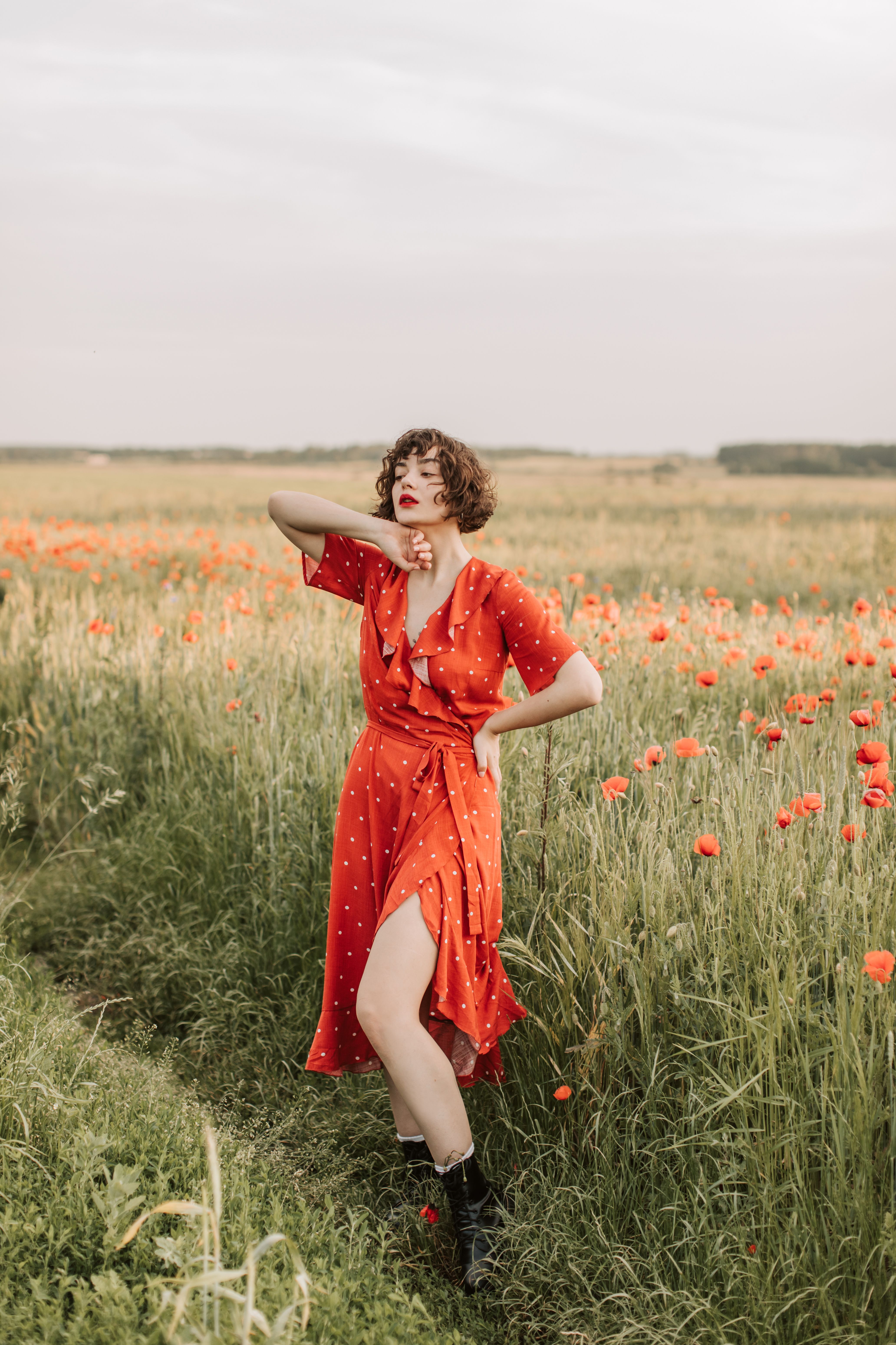 A Woman in Red Dress Posing in the Flower Field · Free Stock Photo