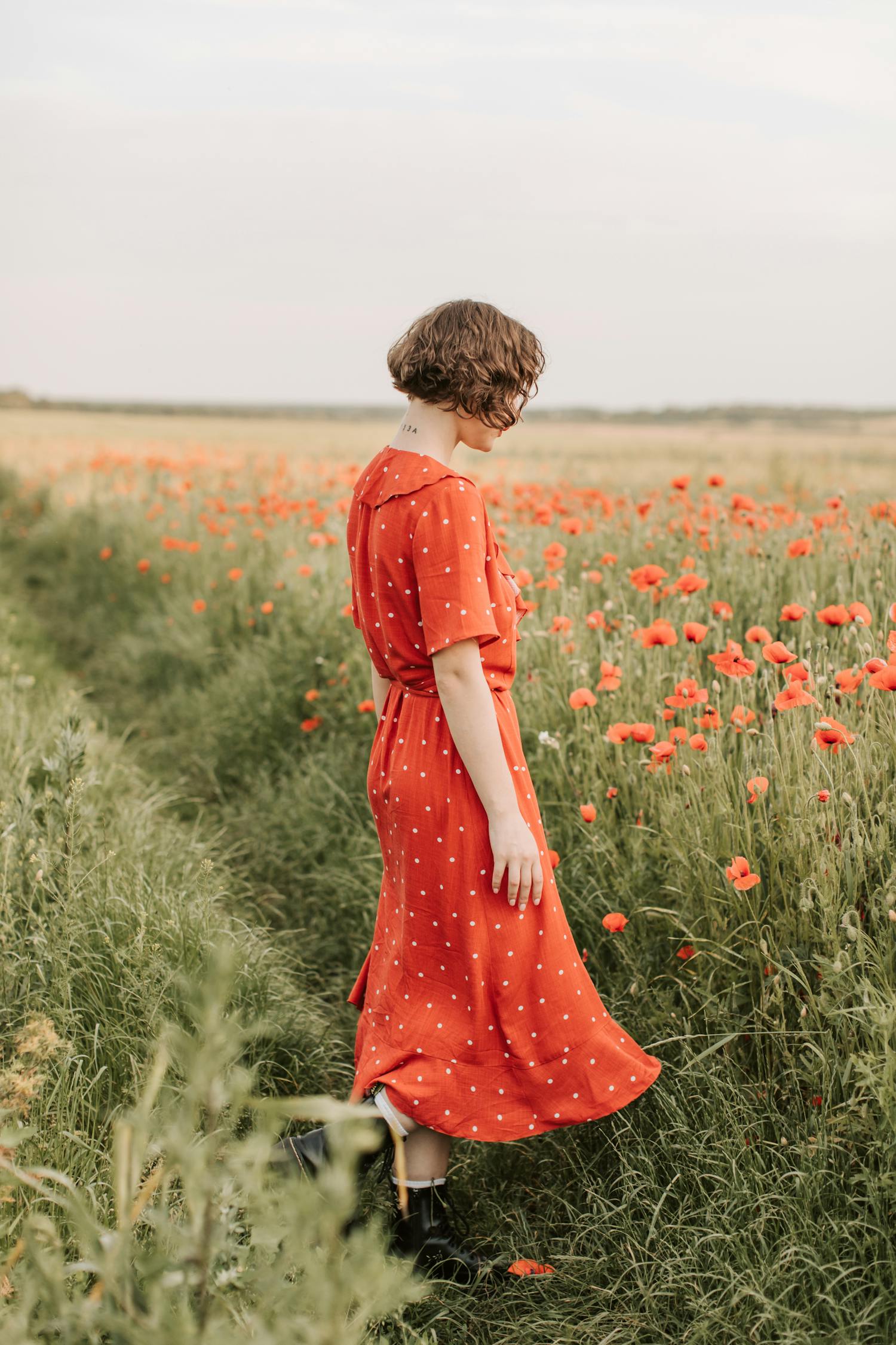 Woman in Red Dress Standing on Green Grass Field · Free Stock Photo