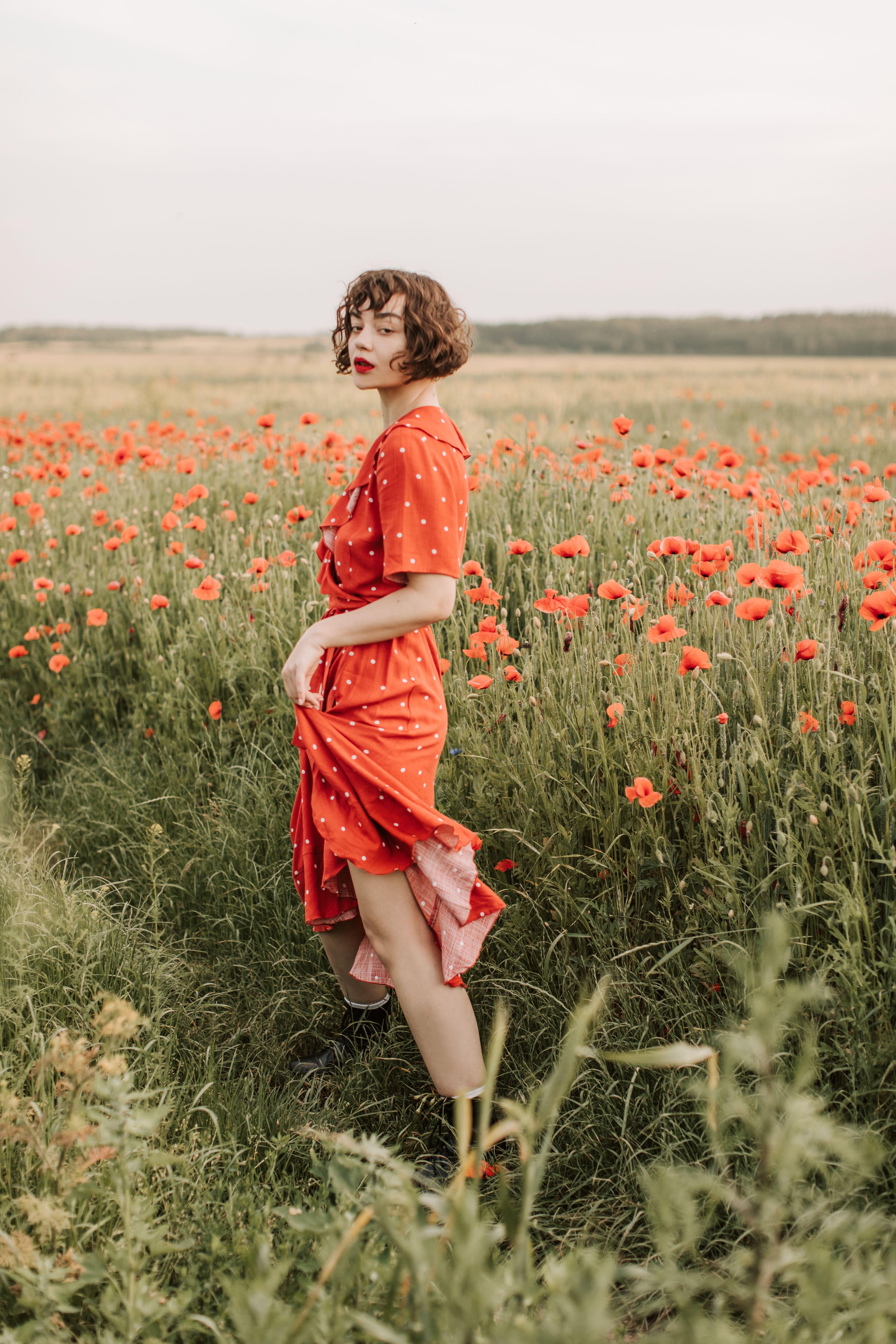 Beautiful Woman Wearing a Red Dress Standing on Poppy Flower Field ...