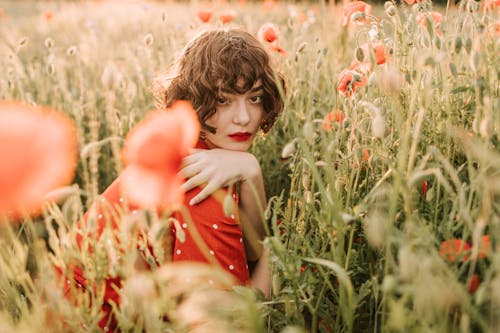 A Woman Sitting in the Flower Field