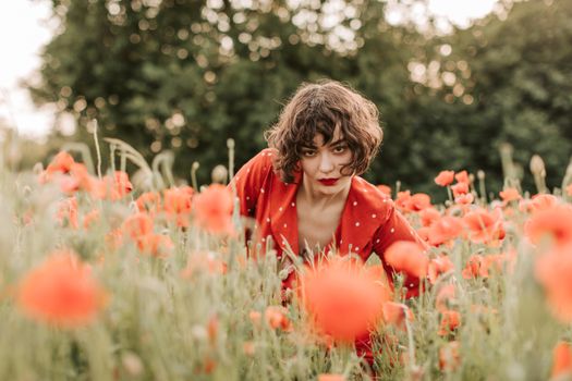 Woman in Red Leather Jacket Standing on Red Flower Field
