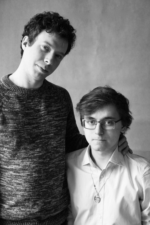 Free A black and white portrait of two men with one having an arm around the other. Stock Photo