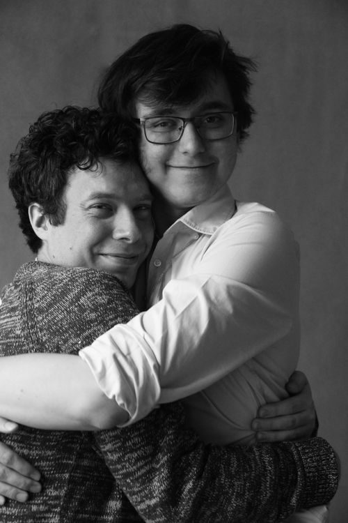 Free Black and white portrait of a joyful couple embracing, showcasing affection and happiness. Stock Photo