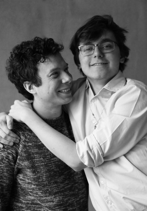 Free Black and white photo capturing the joyful embrace of a gay couple. Stock Photo