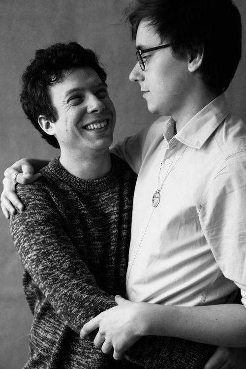 Free Black and white portrait capturing an affectionate embrace between two men, showcasing love and happiness. Stock Photo