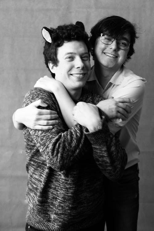 Black and White Photo of Two Men Hugging