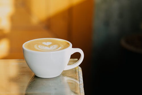 Free Close-Up Shot of a Ceramic Cup of Coffee With Latte Art Stock Photo