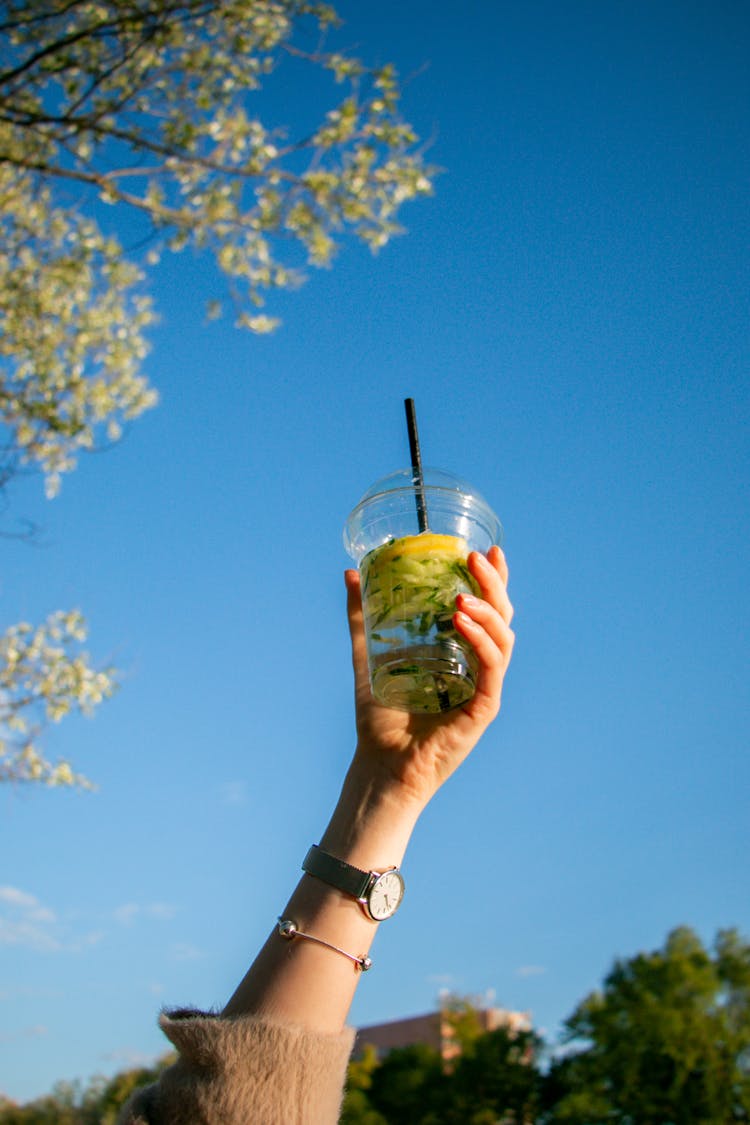 Hand Holding Up A Cocktail