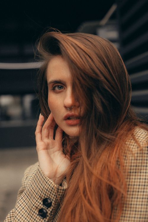 Free Close-up portrait of a woman with piercing, in an outdoor urban setting. Stock Photo