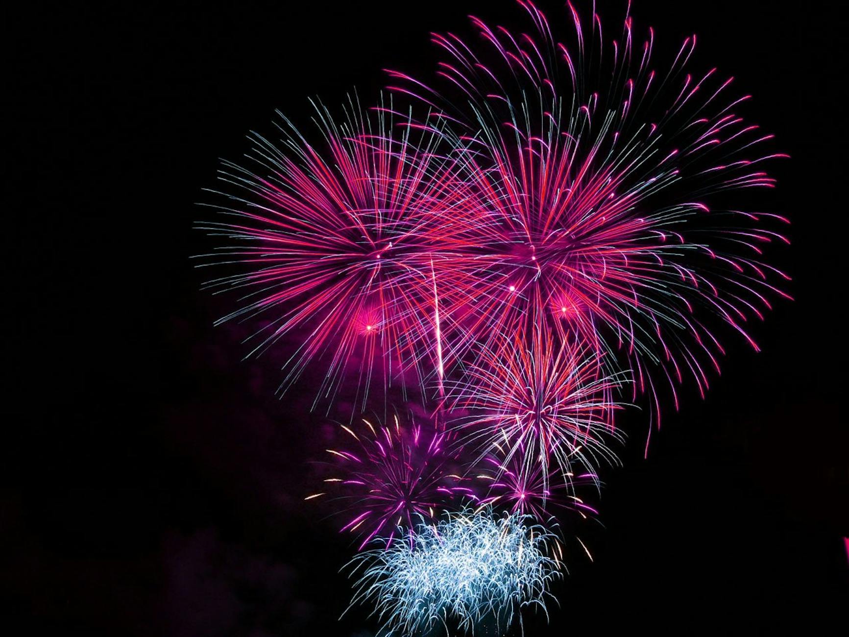 Pink and Blue Fireworks Display during Night Time · Free Stock Photo