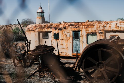 Abandoned rusty wagon and old wheels