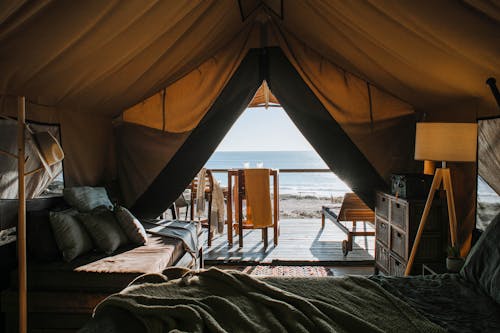 Free Cozy tent with bed and terrace on beach Stock Photo