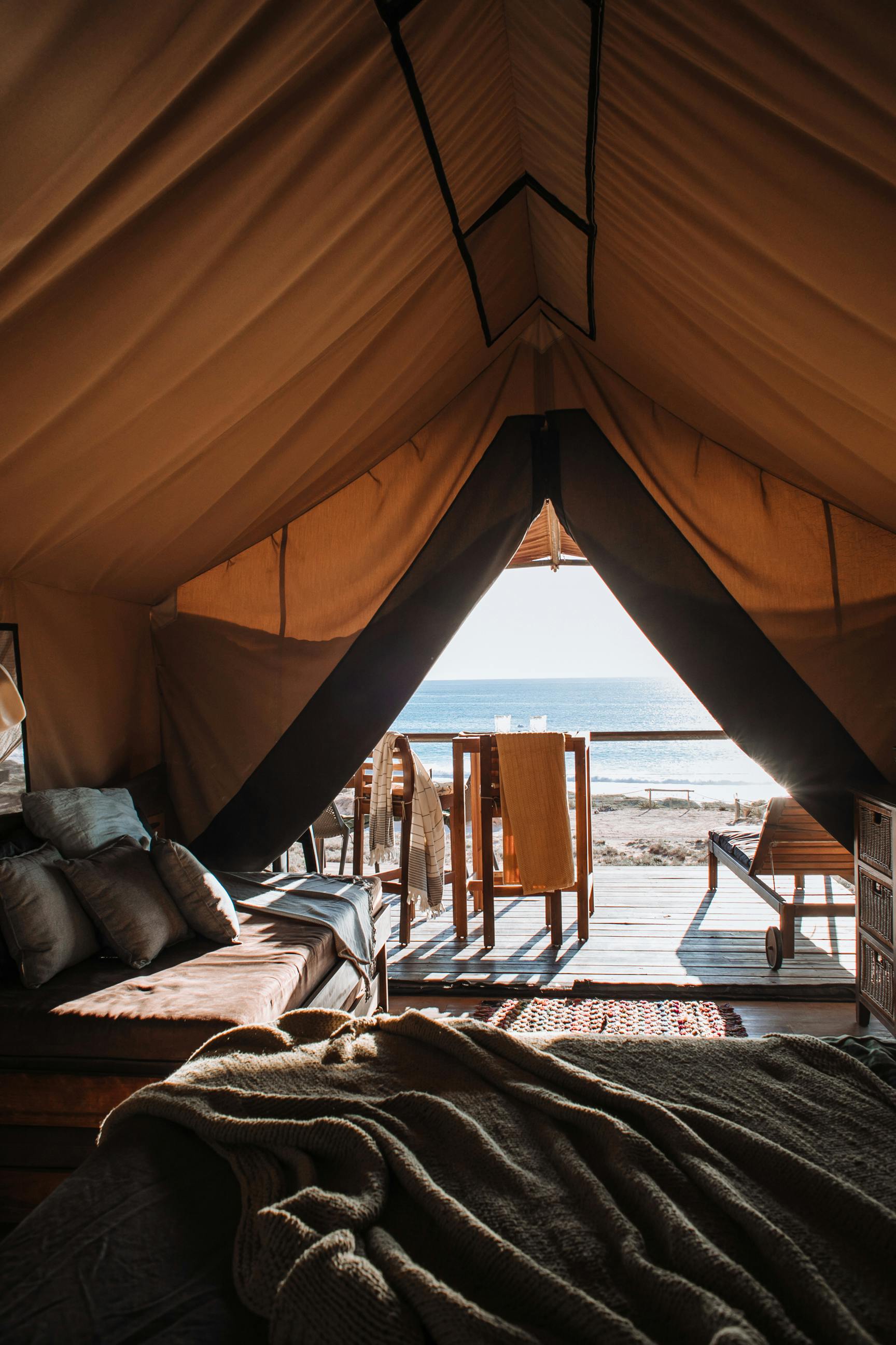 tent with sofa and bed with ocean view