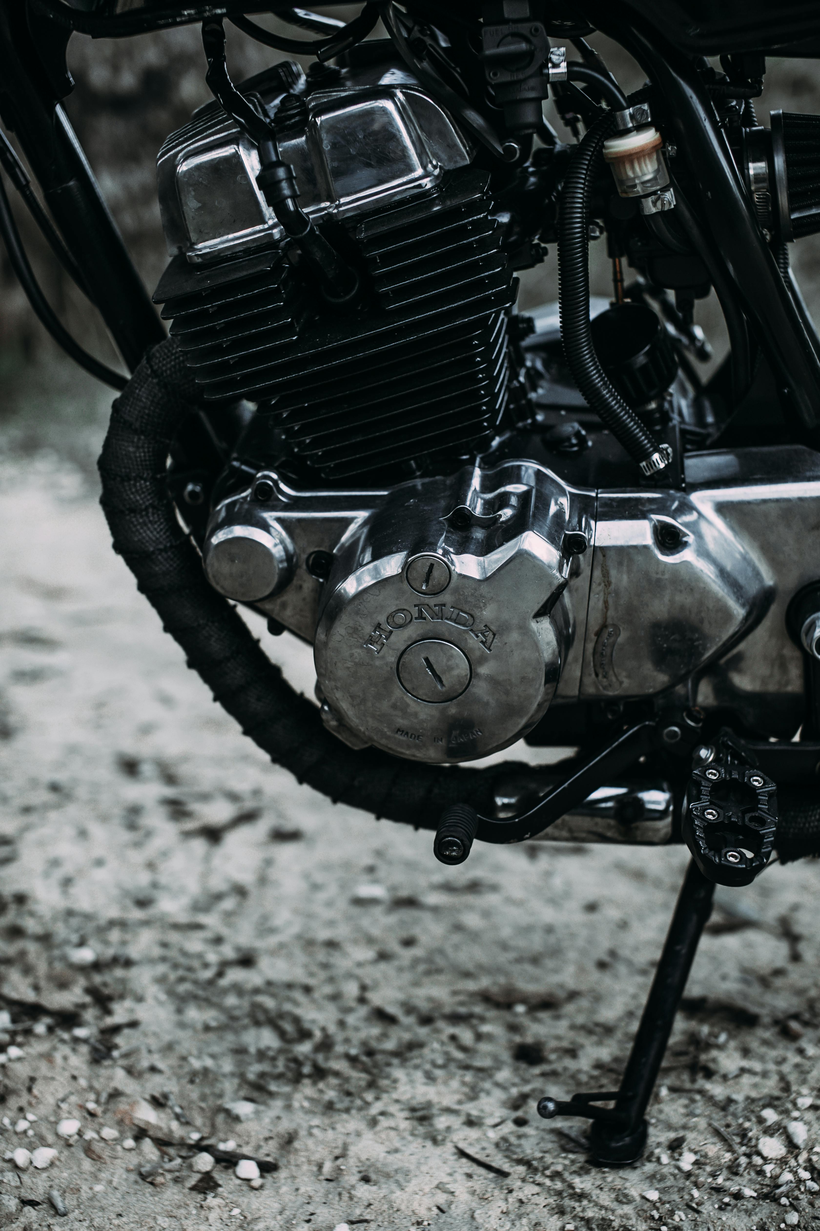 motorcycle parked on sandy road outside