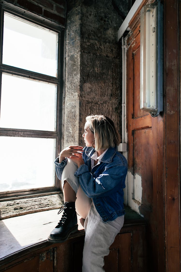 Thoughtful Woman Sitting In Old House