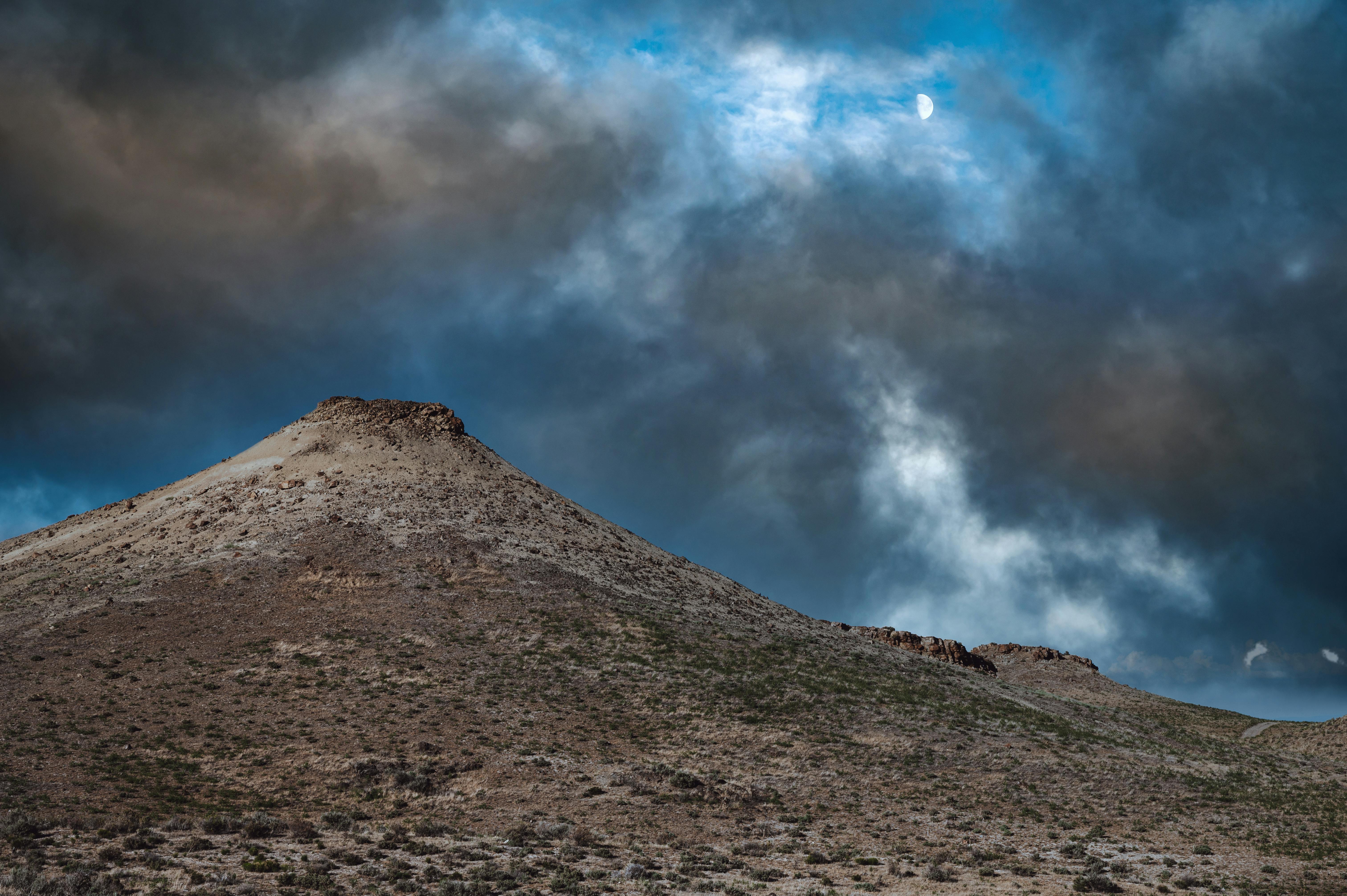 overcast sky over mountain slope