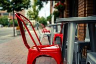 Red chair and gray table near cafe