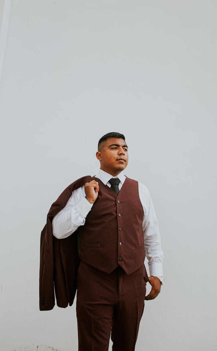 Man In Business Suit Standing Against White Background