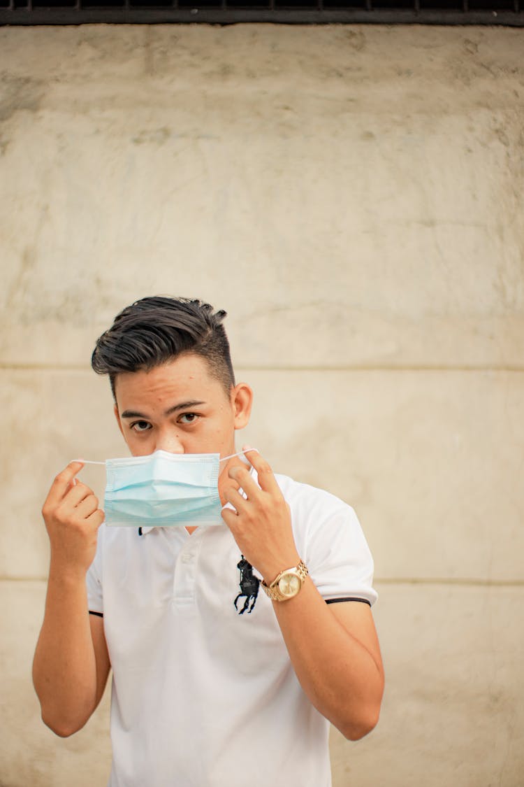 Man Putting On Face Mask