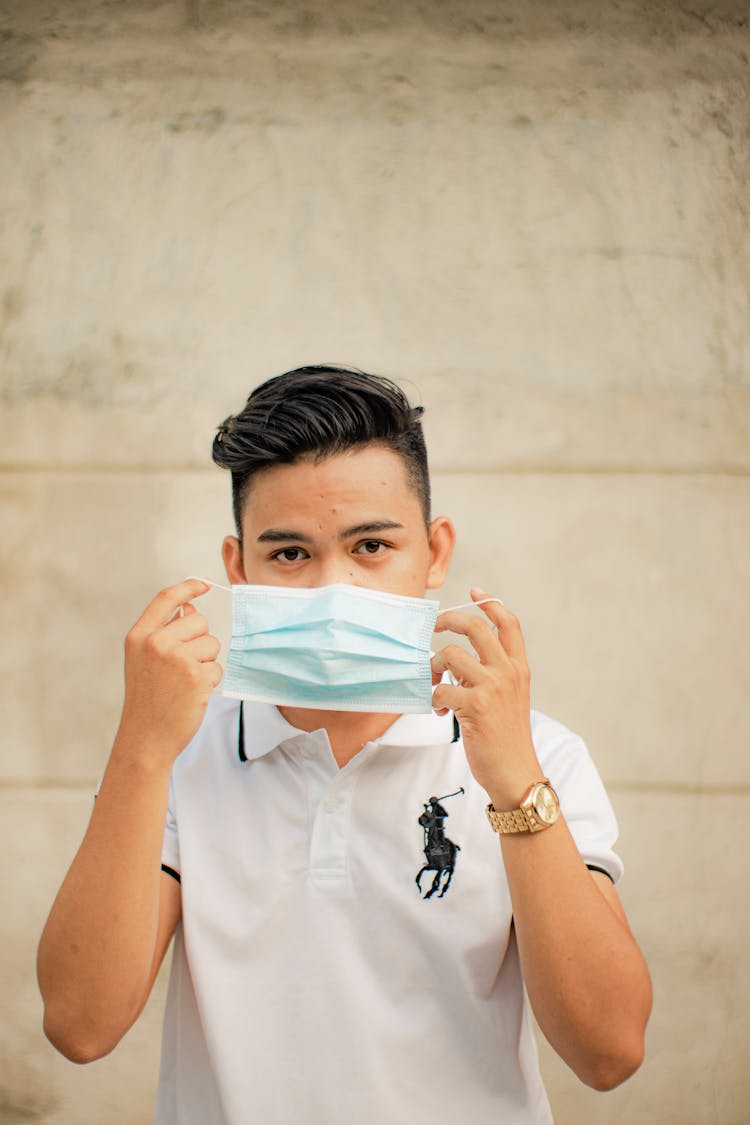 Man Putting On Face Mask