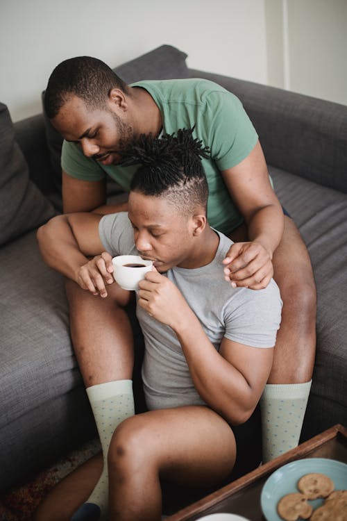 Free Couple Lovers Cuddling Drinking Coffee at Home Stock Photo