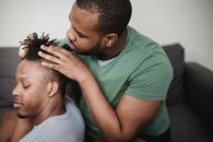 Man in Green Crew Neck T-shirt Kissing Man in Gray Crew Neck T-shirt