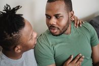 Close up of Two Men Talking and Embracing Each Other