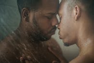 Close-up of Men Having Shower Together