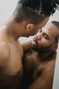 Two Athletic Nude Men Staying Close Together under Shower