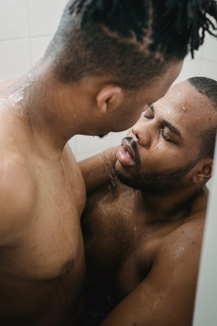 Two Athletic Nude Men Staying Close Together Under Shower