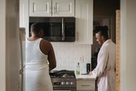 Man in White Tank Top Standing Beside Woman in White Tank Top