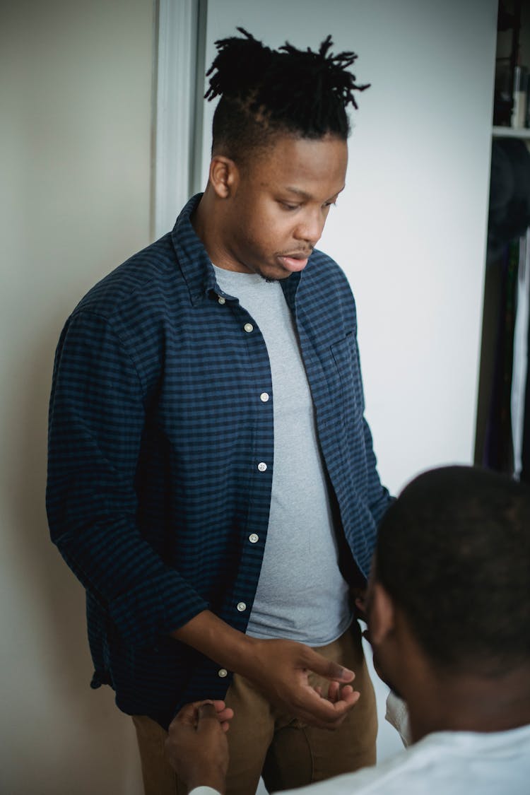 Two Young African American Men Talking In Room