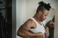 Man with Dreadlocks Wearing a White Undershirt