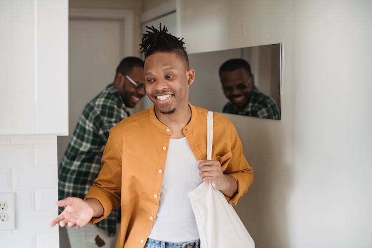 Shot Of Two Men Entering An Apartment