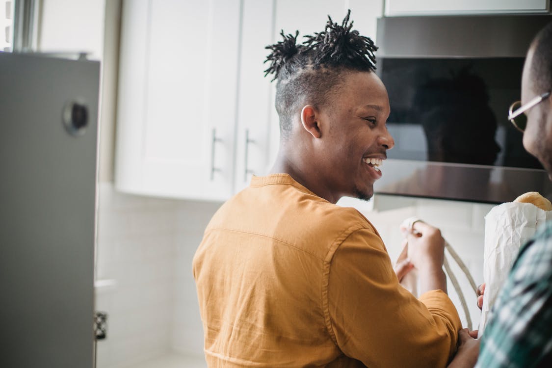 Free Men Laughing in the Kitchen Together  Stock Photo