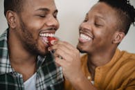 Man Eating Strawberry Served by Partner