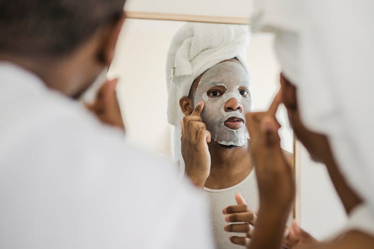 Men Looking In Mirror Doing Facial Procedures